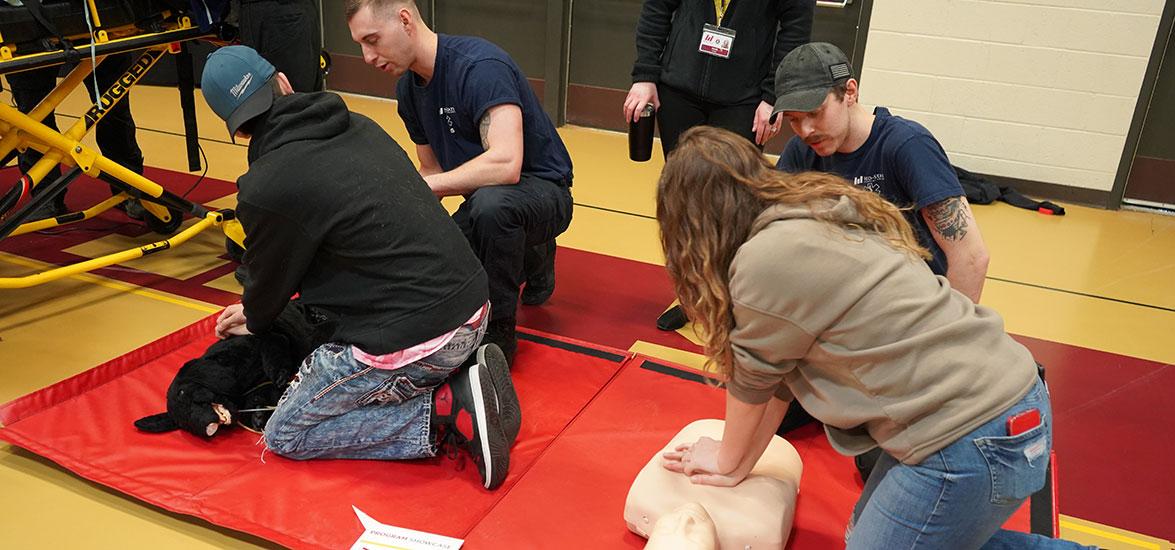 Program Showcase students learn how to provide CPR using a dog and a human manikin in a hands-on career exploration activity for Mid-State’s Emergency Medical Technician and Paramedic Technician programs during the event on the college’s Wisconsin Rapids Campus, March 7.