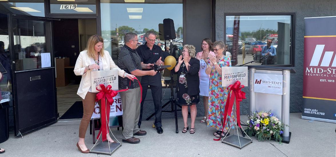 The ribbon is cut at Mid-State Technical College’s new location in Marshfield, Mid-State on Central, June 21, 2023. From left: Jackie Esselman, Mid-State dean of Admissions & Recruitment; Terry Whitmore, Mid-State Board school district administrator member; Dr. Shelly Mondeik, Mid-State president; Charles Spargo, Mid-State Board member and treasurer; Denise Sonneman, executive director of Marshfield Area Chamber of Commerce & Industry (MACCI) and Lois TeStrake, City of Marshfield mayor.
