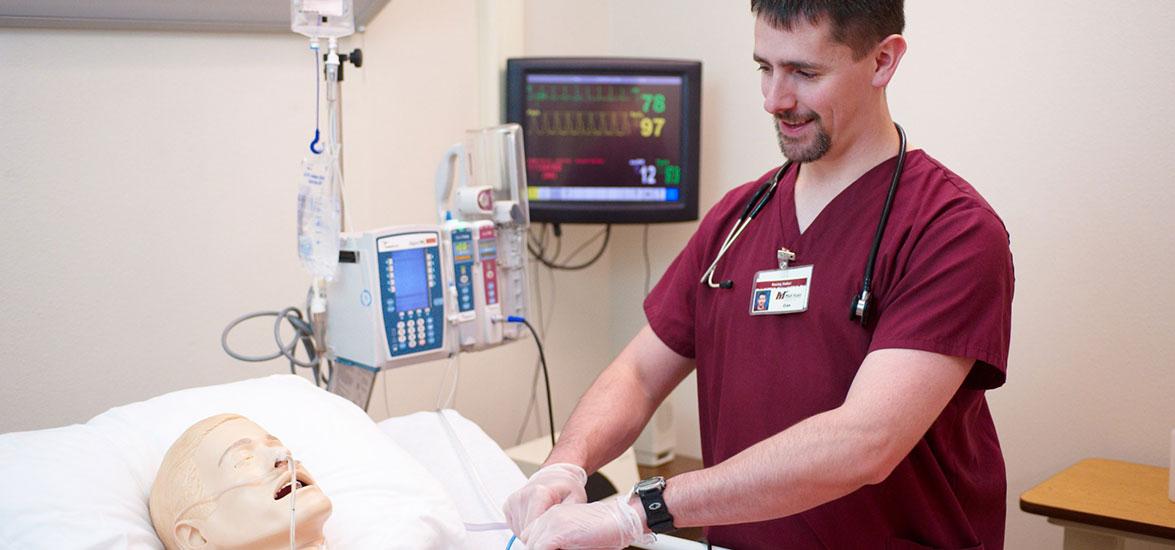 Mid-State Technical College Nursing program student practicing skills on a manakin patient.