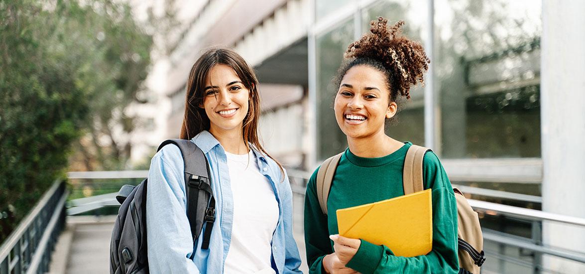 Two students with backpacks and folders.