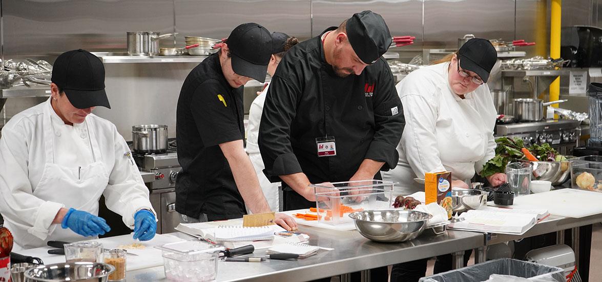 Mid-State Technical College Culinary Arts instructor with students practicing skills in the Culinary Kitchen on the Wisconsin Rapids Campus.