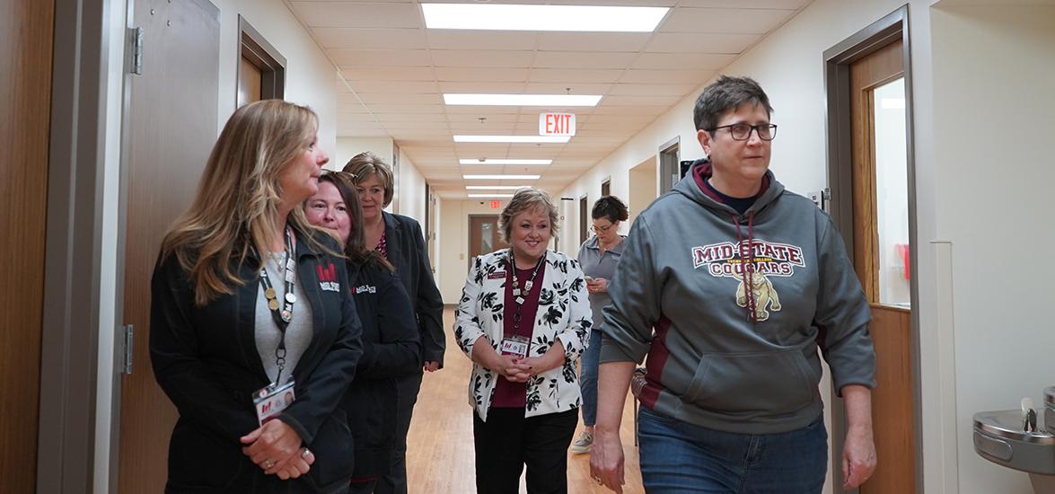 Dr. Morna Foy, Wisconsin Technical College System (WTCS) president, right, tours Mid-State Technical College’s Healthcare Simulation Center in Wisconsin Rapids, April 23, as a stop on her Tour of Excellence. Also pictured: Dr. Shelly Mondeik, Mid-State president, center, and other Mid-State and WTCS staff.