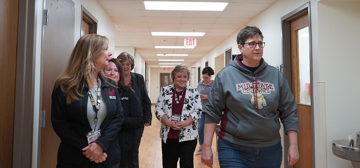 Dr. Morna Foy, Wisconsin Technical College System (WTCS) president, right, tours Mid-State Technical College’s Healthcare Simulation Center in Wisconsin Rapids, April 23, as a stop on her Tour of Excellence. Also pictured: Dr. Shelly Mondeik, Mid-State president, center, and other Mid-State and WTCS staff. 