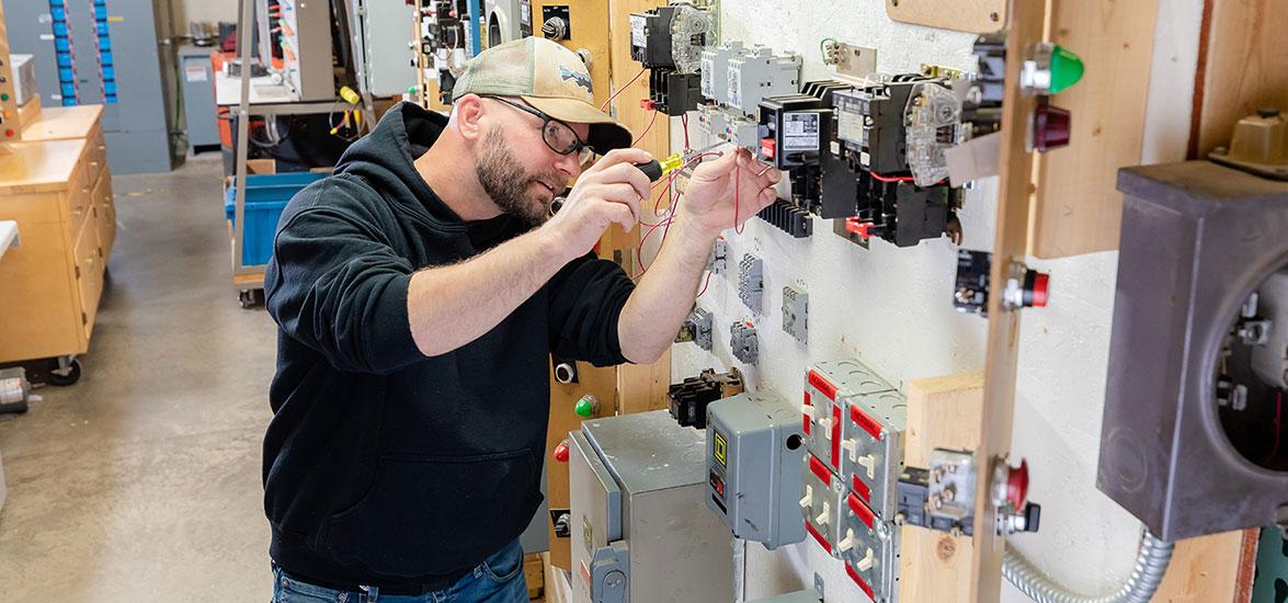 A Mid-State Construction Electrician apprentice practices wiring switches and controls as part of his hands-on training in the program. The apprenticeship is one of 13 offered at Mid-State and eligible for the Tools of the Trade scholarship program each year.