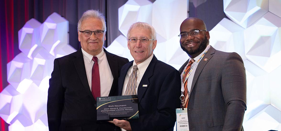 Mid-State Technical College culinary arts instructor Rich Neumann, center, receiving the David R. Prentkowski Distinguished Lifetime Member Award July 19, 2024, at the National Association of College and University Foodservices (NACUFS) National Conference, Louisville, Ky. Also pictured, from left: Kerry Paterson, NACUFS Immediate Past Chairman, Oregon State University, and Kory Samuels, NACUFS Chairman, Rochester Institute of Technology.