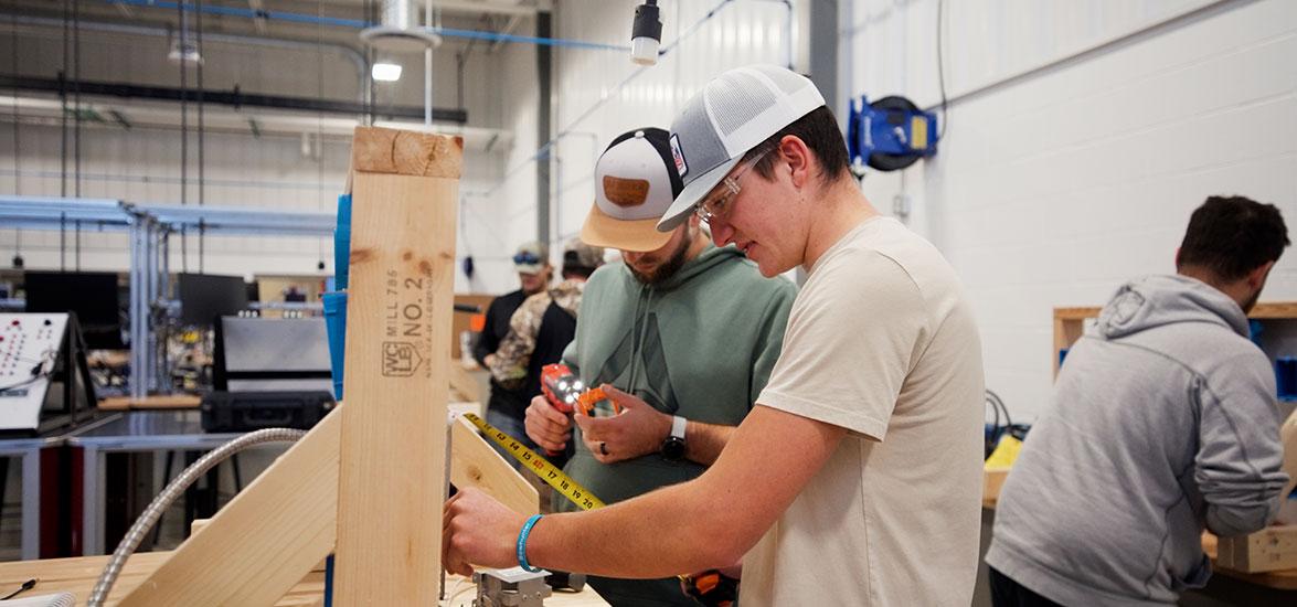 Mid-State Technical College Construction Electrician (IBEW-NECA) apprentices measure to install outlet boxes. The apprenticeship is one of 13 offered at Mid-State and eligible for the Tools of the Trade scholarship program each year.
