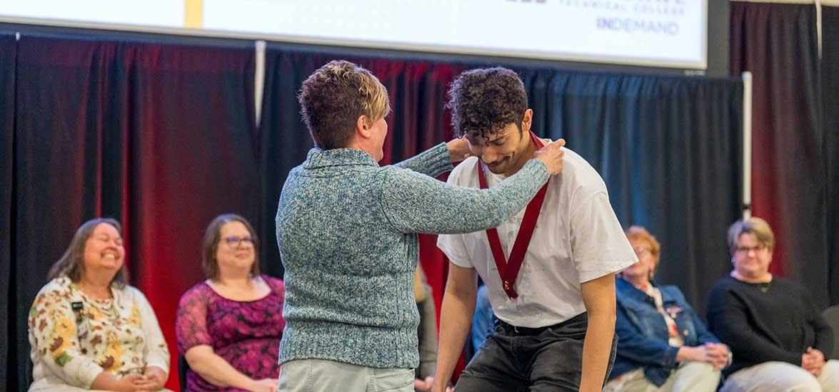 Mid-State Technical College Nursing program graduate Shawn Rones receives his nursing pin from Mid-State Nursing Instructor Tracy Joosten during the College’s pinning ceremony on the Wisconsin Rapids Campus, May 20.
