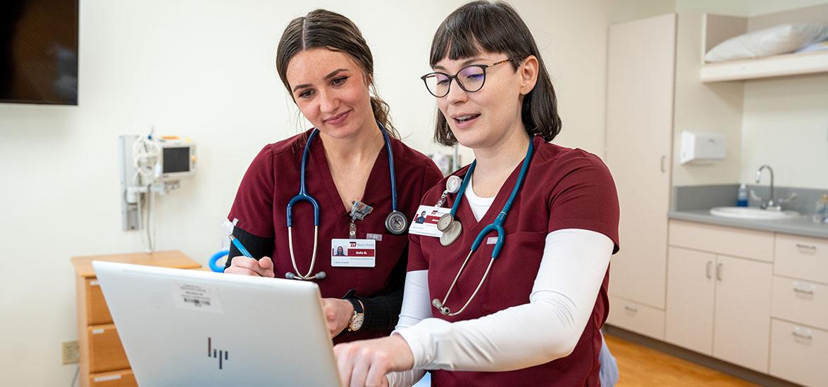 Mid-State Technical College Nursing students working collaboratively to review their patient’s chart in the Healthcare Simulation Center.