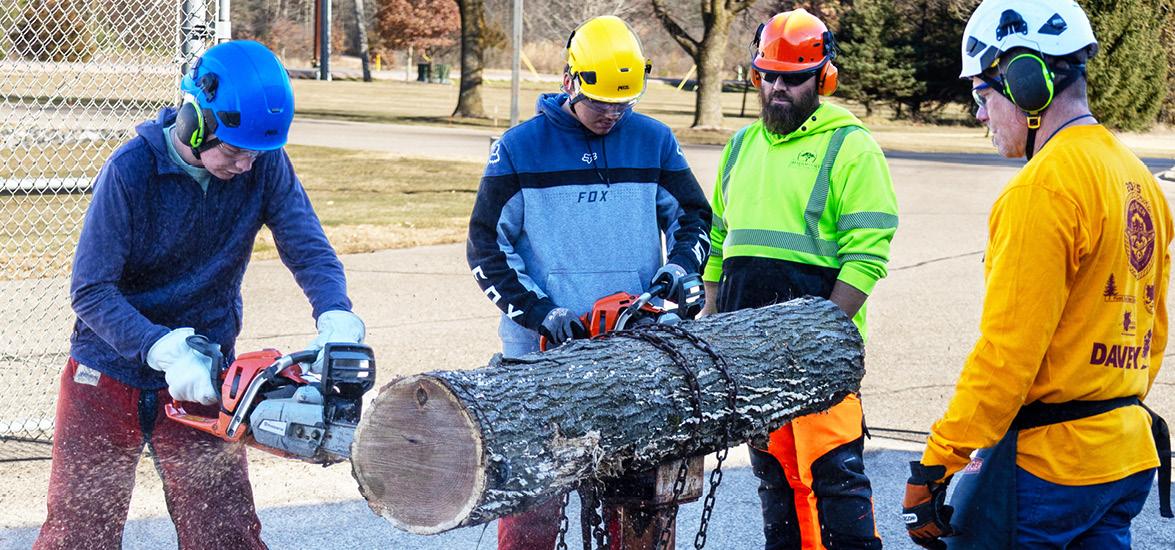Tree Tech 2025 participants get chainsaw training by arboriculture professionals at the Wisconsin Rapids Campus.