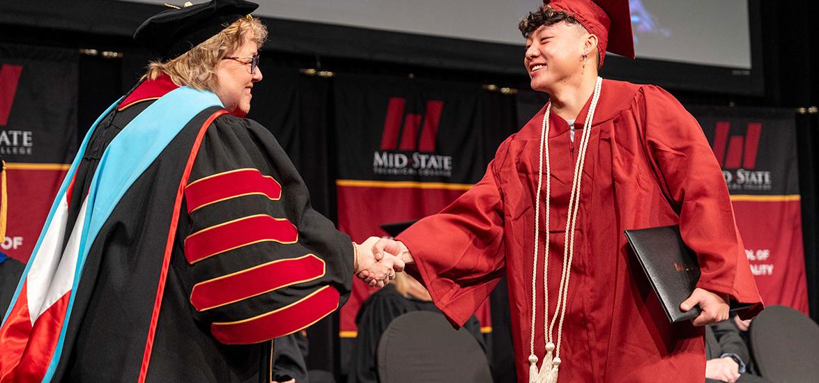 Mid-State Technical College President Dr. Shelly Mondeik congratulates a graduate during the presentation of diplomas at Mid-State’s fall commencement on the Wisconsin Rapids Campus, Dec. 13, 2025.