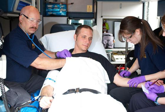 Medical team in an ambulance assess a patient.