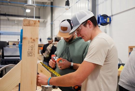 Mid-State Technical College Construction Electrician (IBEW-NECA) apprentices measure to install outlet boxes. The apprenticeship is one of 13 offered at Mid-State and eligible for the Tools of the Trade scholarship program each year.