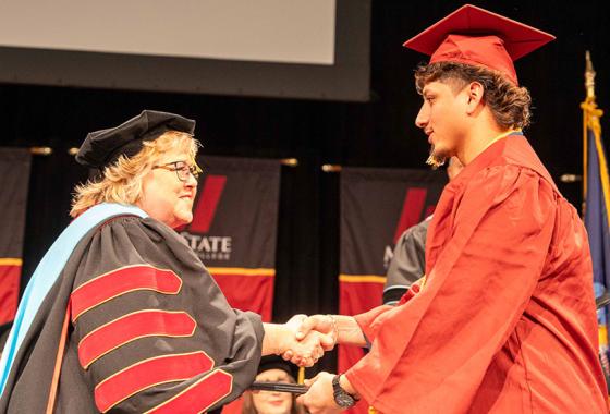 Mid-State President Dr. Shelly Mondeik congratulates a graduate during the presentation of diplomas at the College’s fall commencement on the Wisconsin Rapids in December. Spring commencement will be held on Saturday, May 17, on the Wisconsin Rapids Campus.