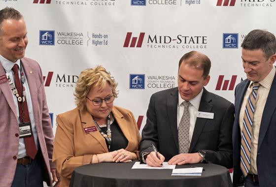 Leadership from Mid-State Technical College and Waukesha County Technical College sign the agreement to offer a new shared AI Data Specialist associate degree at a Feb. 6 signing event at the AMETA Center. 