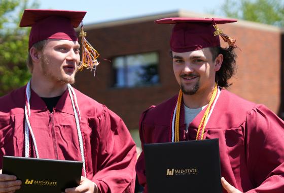 Two Mid-State Technical College graduates just after receiving their diplomas at the spring commencement on the Wisconsin Rapids Campus, May 16, 2026.